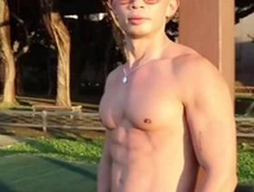 Enjoying the evening sunset while appreciating the beauty of muscle worship and big pecs in an Asian hunk.
