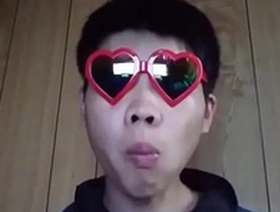 Young gay Japanese man masturbates on camera.